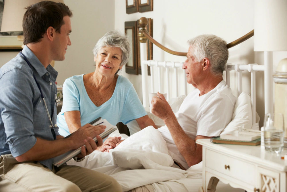 A man and woman talking to an older couple.